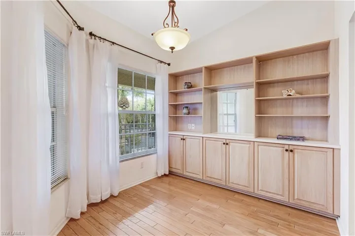 Unfurnished dining area with light wood-style floors and lofted ceiling