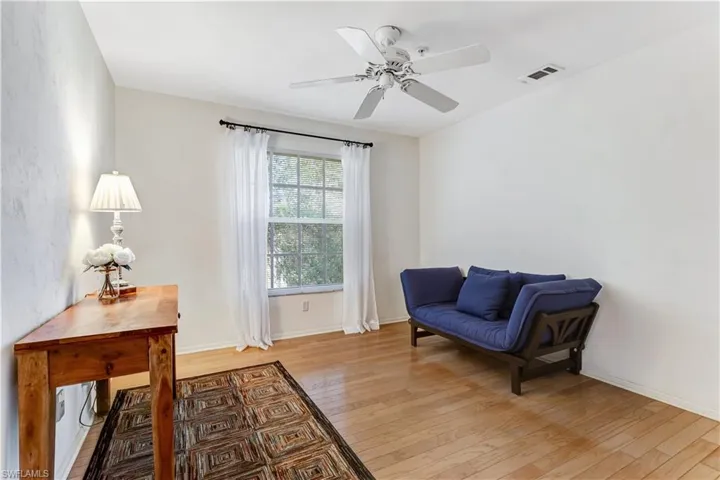 Sitting room featuring light wood-type flooring and a ceiling fan