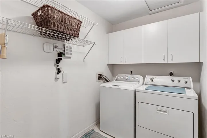 Laundry area featuring washer and clothes dryer and cabinet space