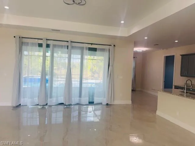 Unfurnished room with light marble finish flooring and recessed lighting