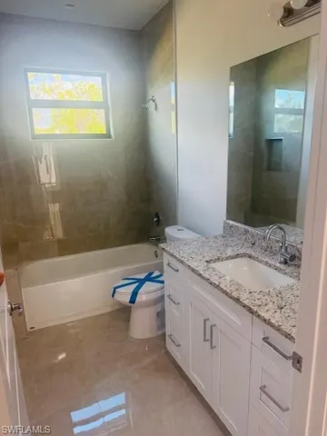 Full bathroom featuring vanity and  shower combination