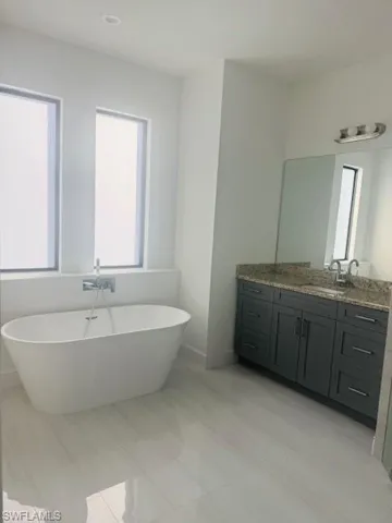 Full bathroom featuring a freestanding bath and vanity
