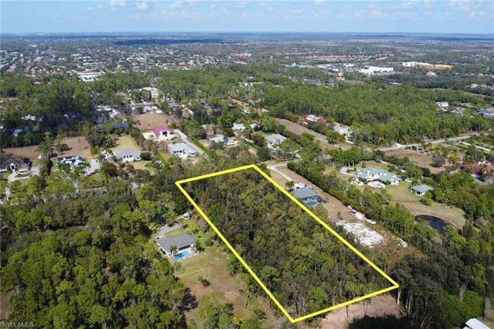 Aerial perspective of suburban area featuring property parcel outlined