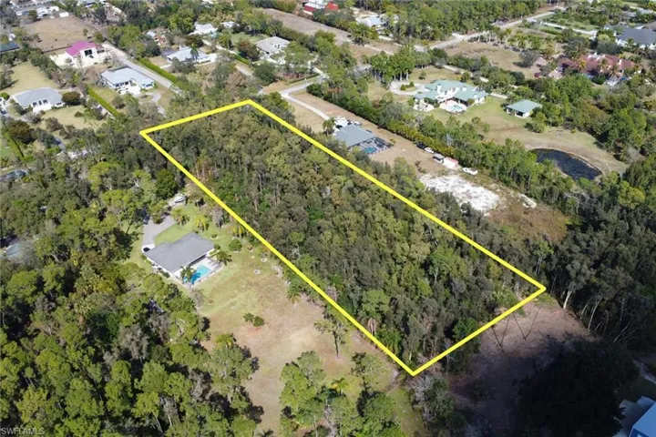 Aerial view of residential area with property boundaries highlighted