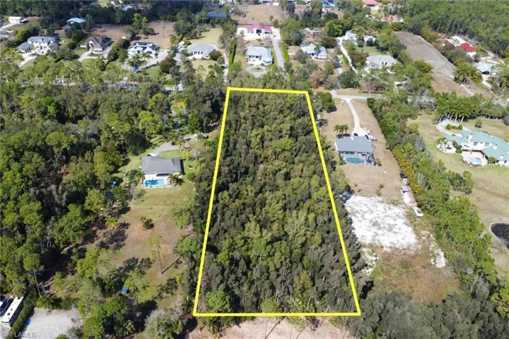 Aerial perspective of suburban area featuring property parcel outlined