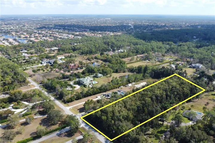 Aerial view of residential area featuring property boundaries highlighted