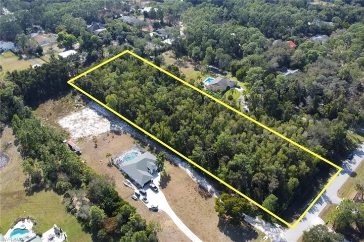 Aerial view of property and surrounding area with property parcel outlined