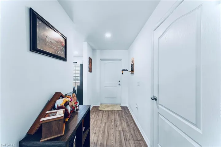 Entryway with baseboards and wood finished floors
