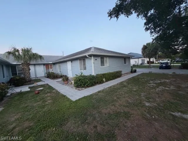 FRONT VIEW WITH VIEW OF PARKING LOT
