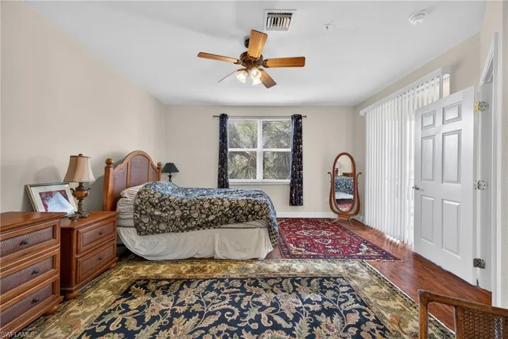 Bedroom with ceiling fan and wood finished floors
