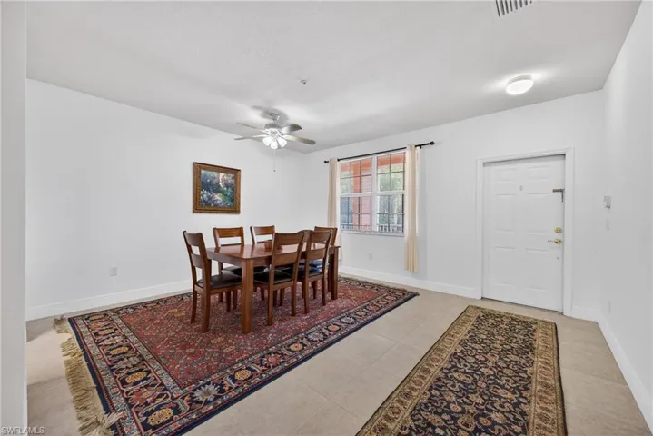Dining area featuring ceiling fan and light tile patterned floors