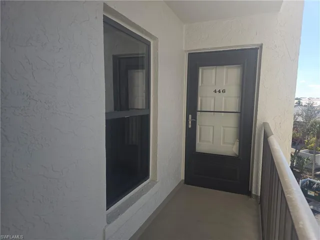 Entrance to property with stucco siding