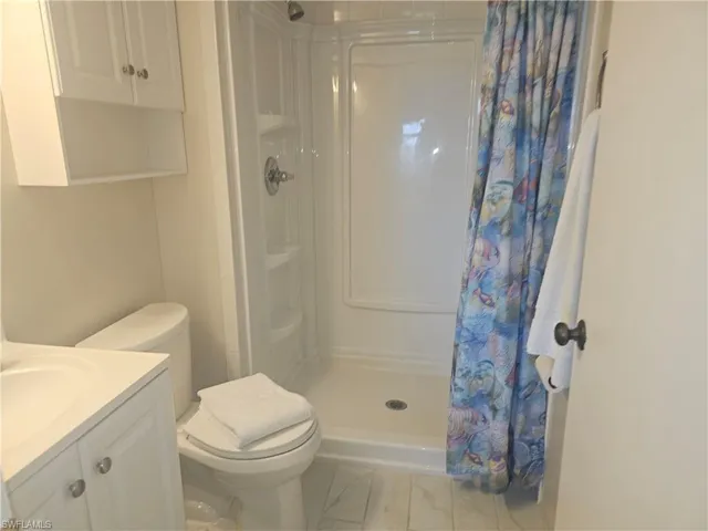 Bathroom with a stall shower and vanity