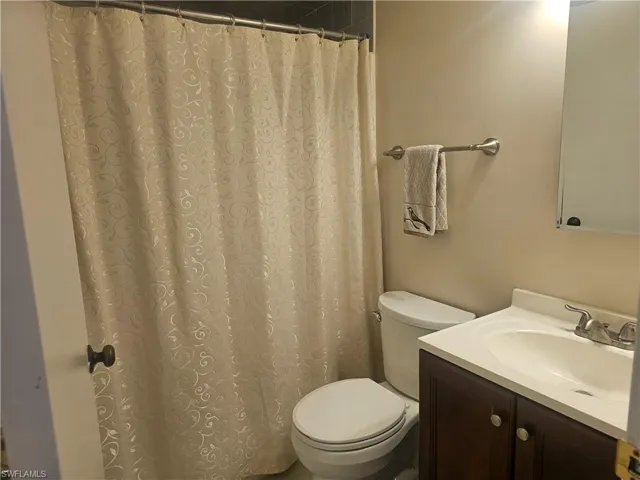 Full bath with vanity and a shower with curtain