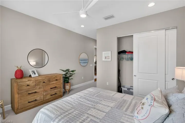 Neutral-toned bedroom featuring recessed lighting and a ceiling fan