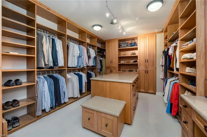 Spacious closet featuring light colored carpet