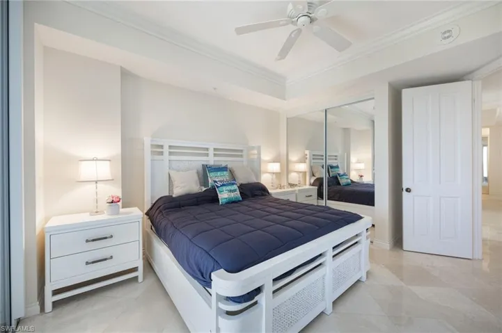 Bedroom featuring ornamental molding, ceiling fan, and a closet