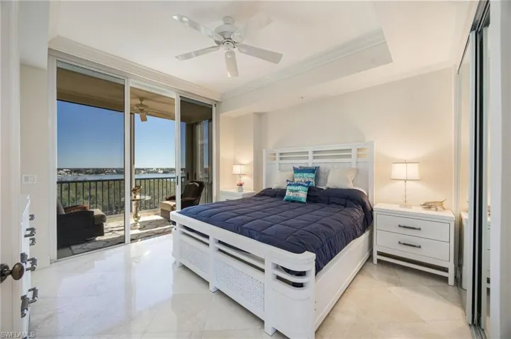 Bedroom featuring expansive windows, ornamental molding, a ceiling fan, access to outside, and a water view