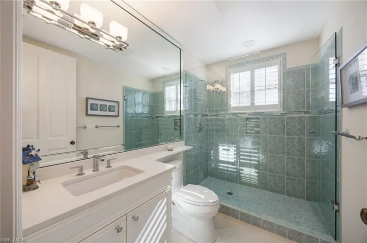 Bathroom featuring vanity, a shower stall, and light tile patterned floors