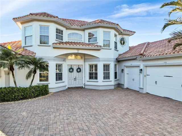 Mediterranean / spanish-style home with a garage