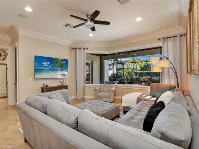 Living room with ceiling fan and crown molding