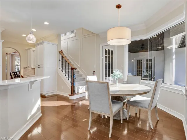 Dining room featuring french doors, dark hardwood / wood-style floors, and ornamental molding