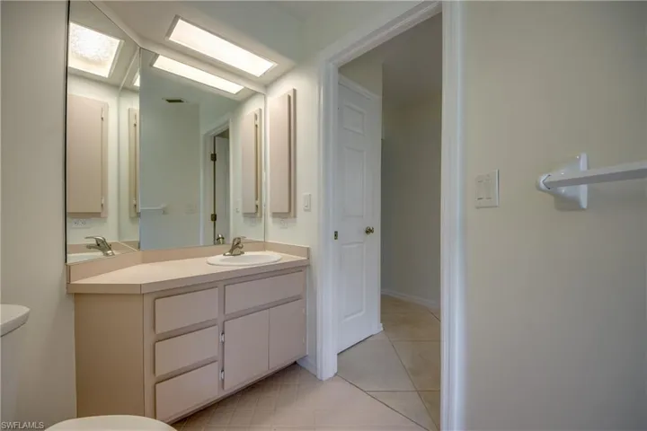 Bathroom with tile patterned floors, toilet, and vanity