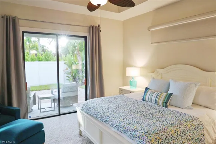 Bedroom featuring access to exterior, ceiling fan, and carpet floors