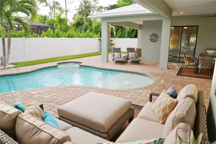 View of pool with an outdoor living space and a patio area