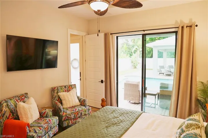 Cabana bedroom with hardwood / wood-style flooring, ceiling fan, and access to outside
