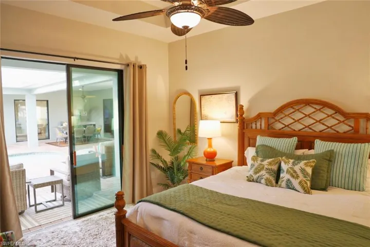 Cabana bedroom featuring ceiling fan and access to exterior