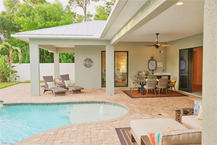 View of pool with ceiling fan and a patio area