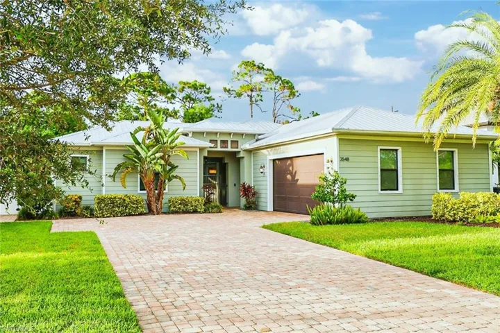 View of front of home featuring a front lawn and a garage
