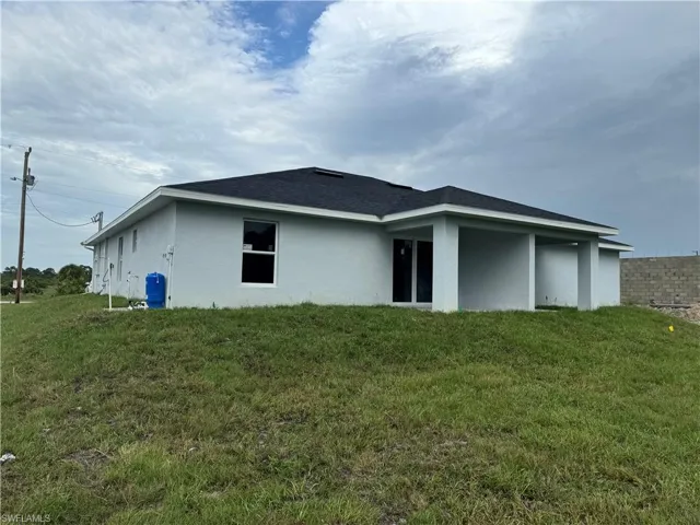 Rear view of house with a yard