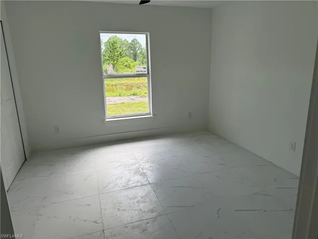 Spare room featuring light tile patterned floors