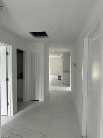Hall featuring light tile patterned floors