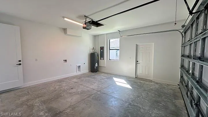 Garage with baseboards and water heater