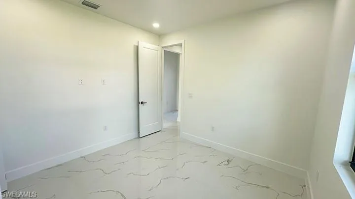 Unfurnished room with baseboards and recessed lighting