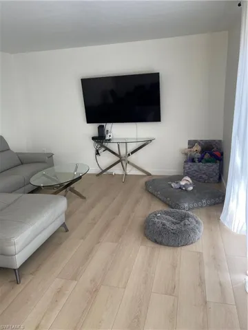 Living room with light hardwood / wood-style floors