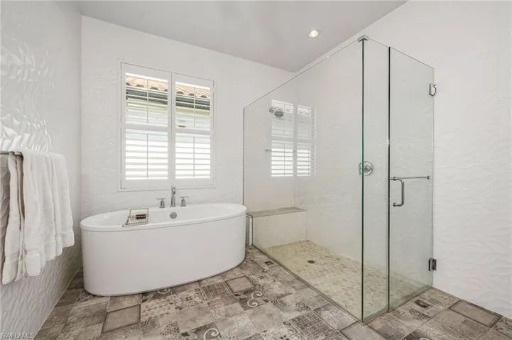 Bathroom with gorgeous tile floors, soaking tub and walk in shower