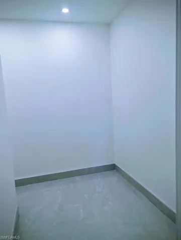 Unfurnished room featuring baseboards and concrete floors