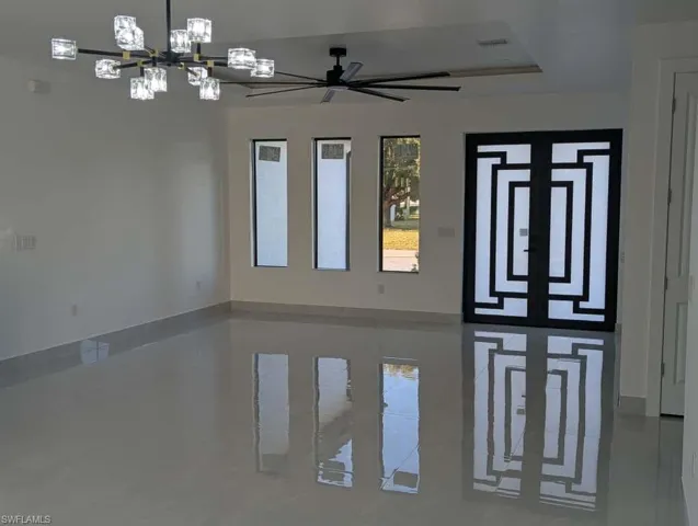 Foyer entrance featuring a chandelier and ceiling fan
