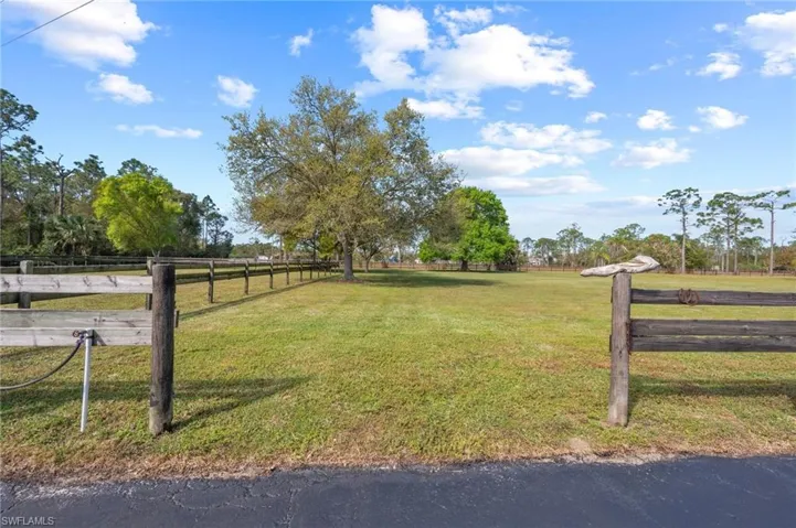 View of yard featuring a rural view and fence