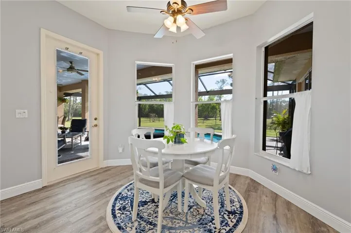 Dining room with light wood-style flooring, a wealth of natural light, and baseboards