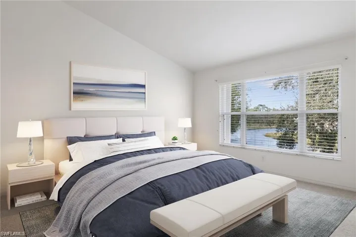 Carpeted bedroom featuring vaulted ceiling