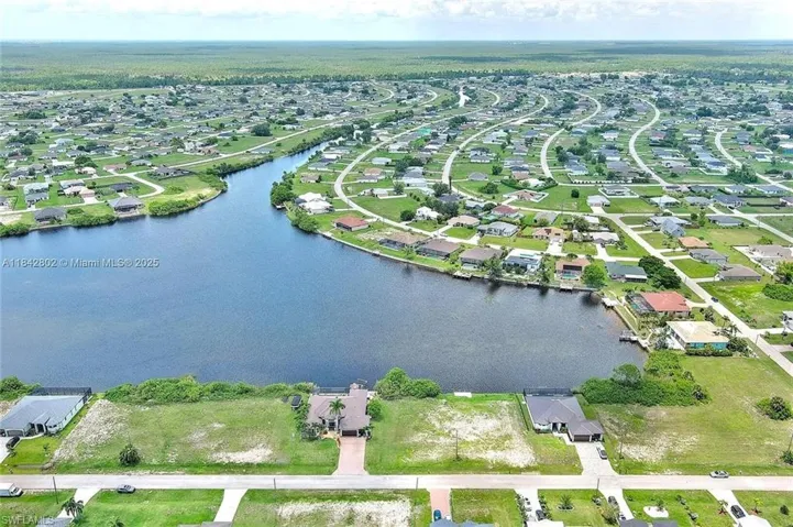 Aerial view of property's location featuring nearby suburban area and a large body of water