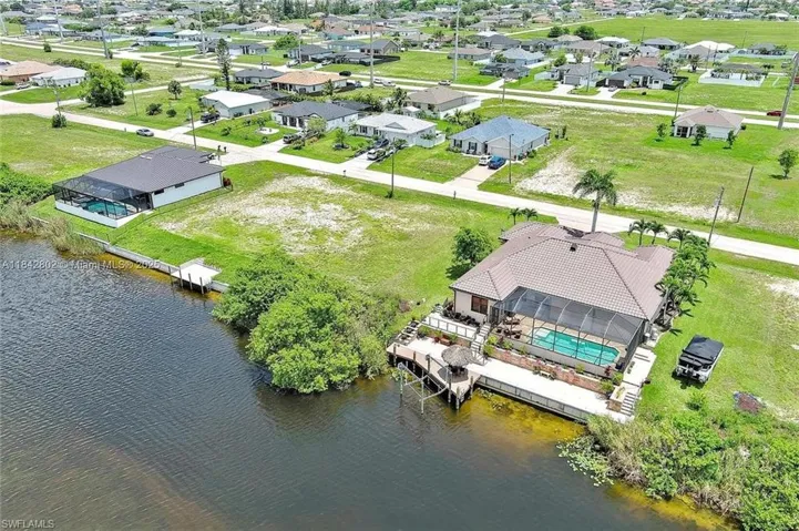 Aerial perspective of suburban area with a large body of water
