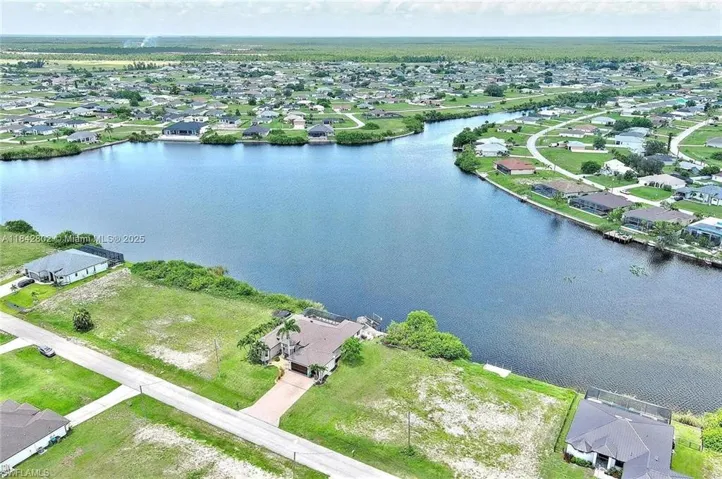 Aerial perspective of suburban area with a large body of water