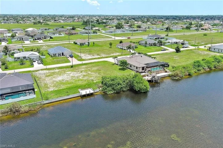 Aerial view of residential area featuring a large body of water