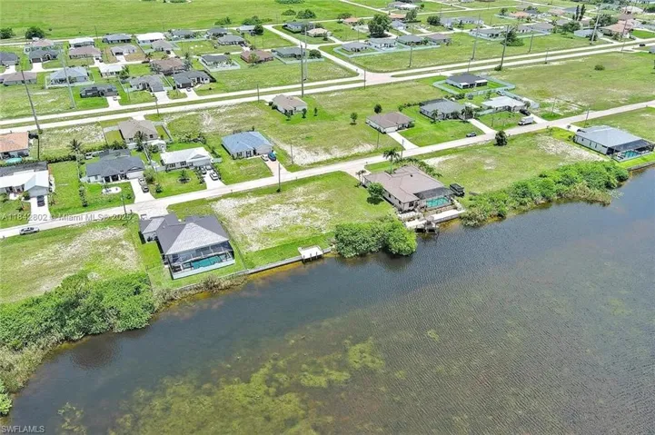 View of property location featuring a large body of water and nearby suburban area